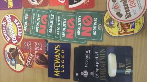 A COLLECTION OF ASSORTED BEER MATS COASTERS