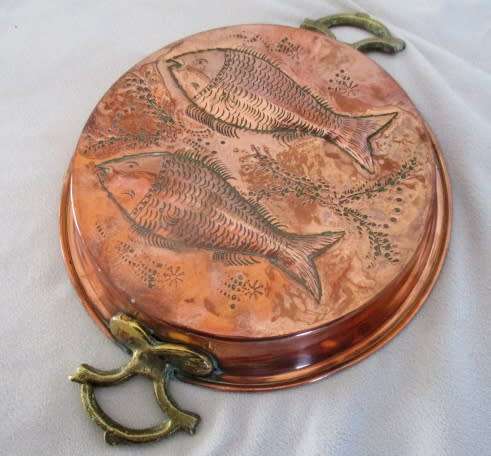 A stunning copper plated pan with brass hanging hooks.