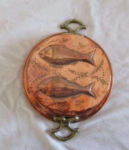 A stunning copper plated pan with brass hanging hooks.