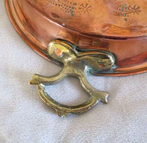 A stunning copper plated pan with brass hanging hooks.