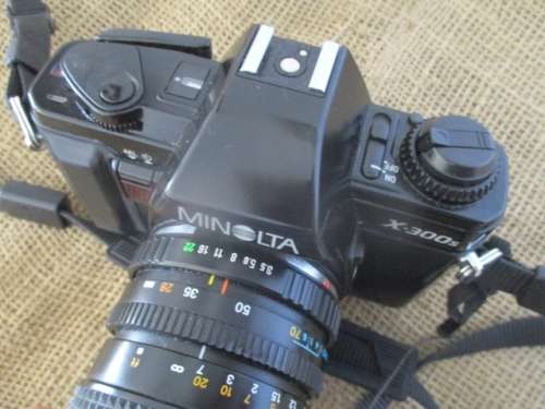 Popular Vintage Minolta X-300s SLR Camera With Film And Attached Minolta MD Zoom 28 - 70 mm Lens
