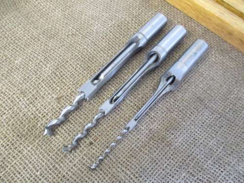 Nice Set Of Square Hole Drill Bits In A Beveld Edged Lidded Wooden Box Plus Drill Attachment.
