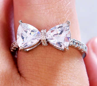 COURIER DELIVERY. Sparkling White CZ Bow Trillion Cut Ring. Size 6-10 available.