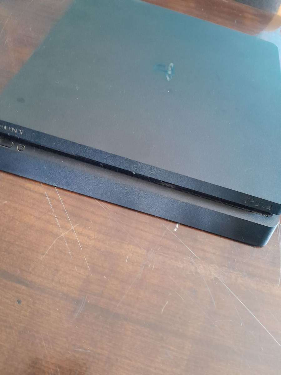 Pre owned ps4 SLIM with 2 games and cooling fan with charging port