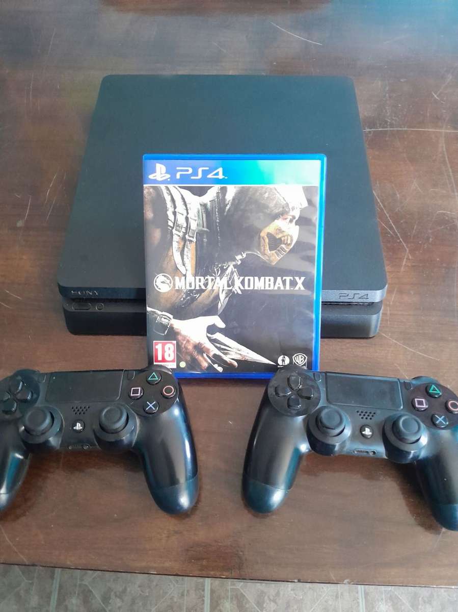 Pre owned ps4 SLIM with 2 games and cooling fan with charging port