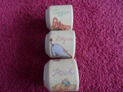 Set of three Winnie the poh by royal doulton egg cups beautiful.