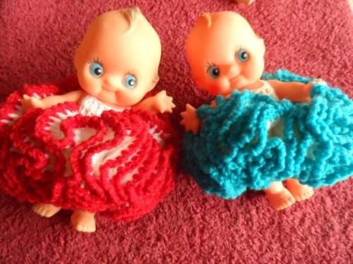 Two small kewpie dolls dressed