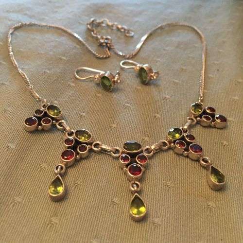 Sterling silver necklace and earrings with garnets and peridots