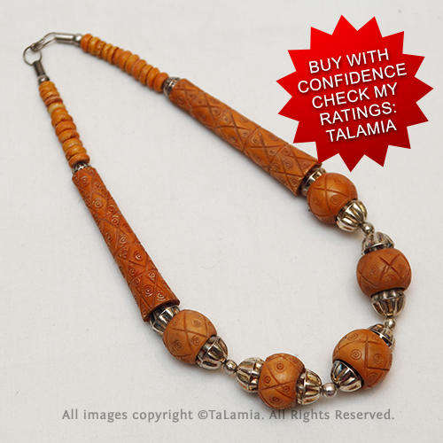 Finely carved tan brown bone beads with antique silver colour details