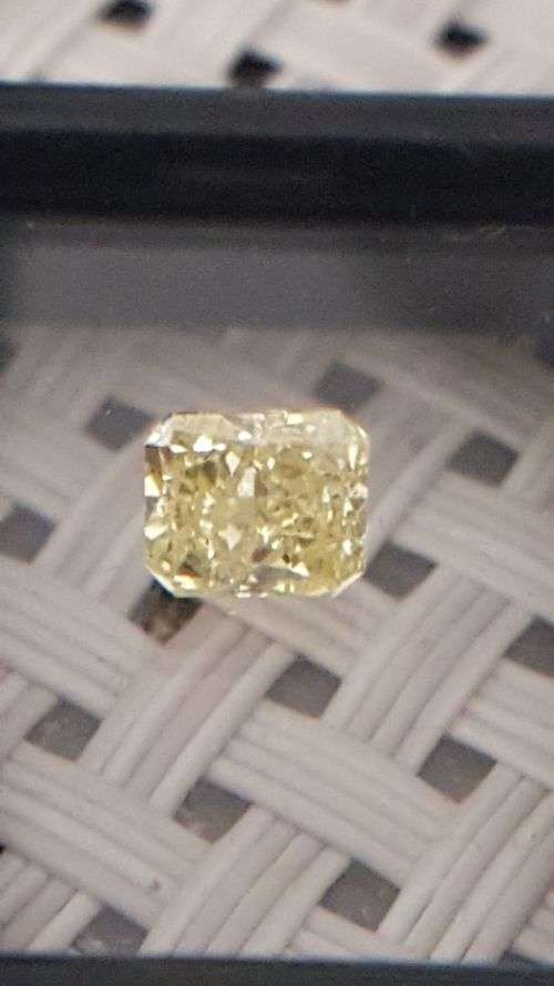 Cert. 0.61Cts Fancy Yellow VS2 Radiant Natural Diamond