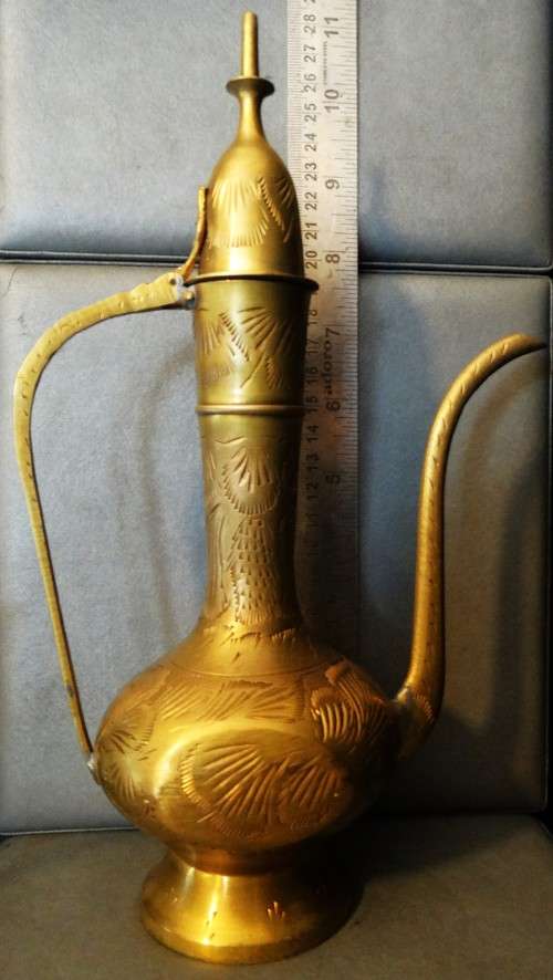 Beautiful set of etched vintage Indian teapots with intricate patterns.