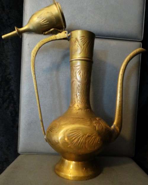 Beautiful set of etched vintage Indian teapots with intricate patterns.