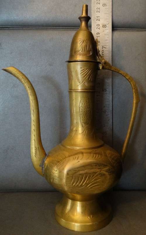 Beautiful set of etched vintage Indian teapots with intricate patterns.