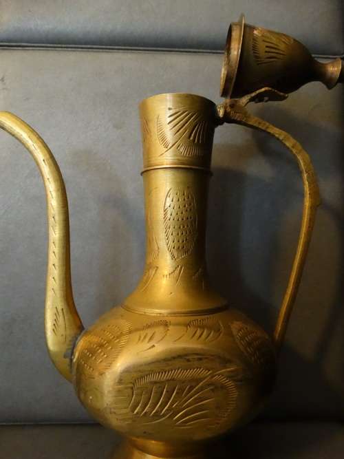 Beautiful set of etched vintage Indian teapots with intricate patterns.