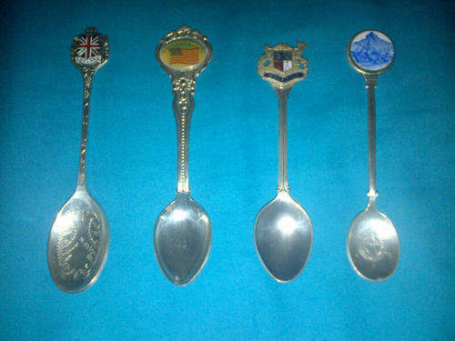 4  silver plated collectible  spoons with detailed engravings. A simple must have