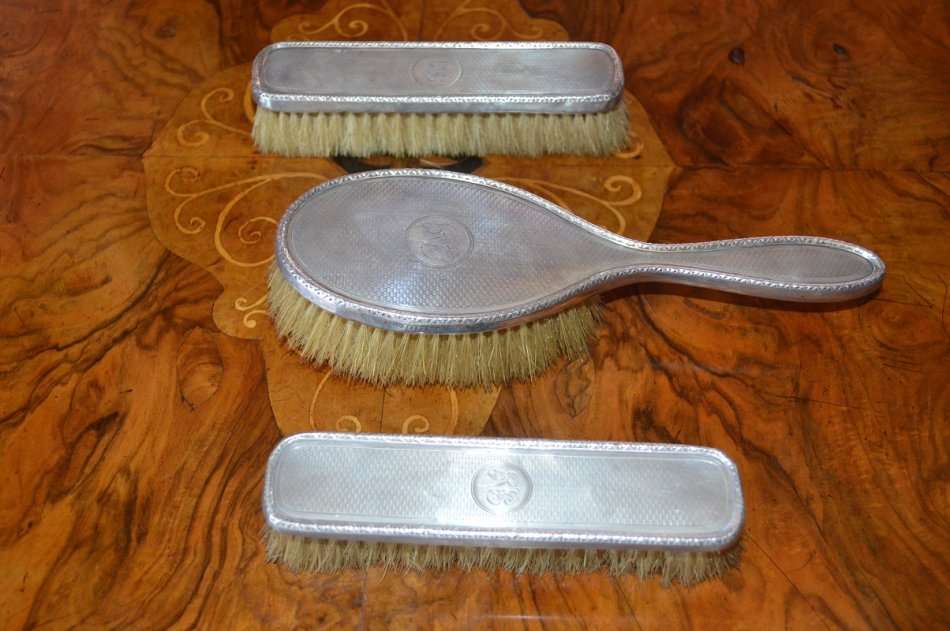 set of 3 silver hallmarked Birmingham Art Deco grooming brushes