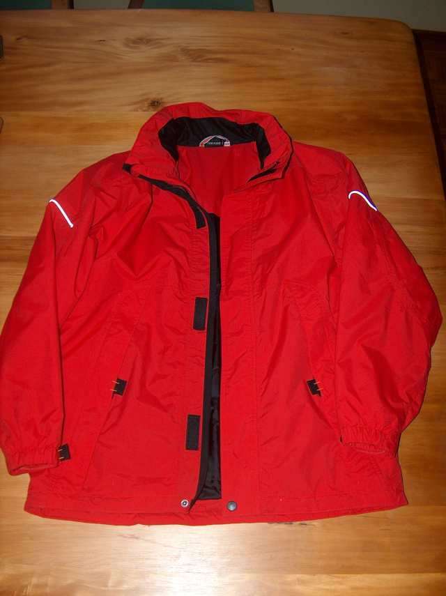 Stihl Timbersports Red jacket, lots of pockets and rollaway hood Size 164 Will also fit Small lady