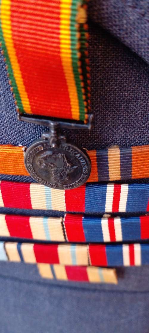 VINTAGE SAAF TUNIC WITH AUTHENTIC WW  11 MINI MEDALS AND SERVICE MEDAL RIBBON STACKS. SEE DESC.
