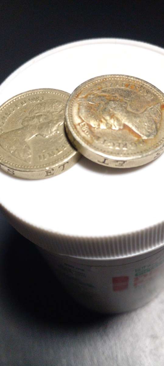 1983 British one pound coin.ERROR : See lettering upside down on the Rim of the coin
