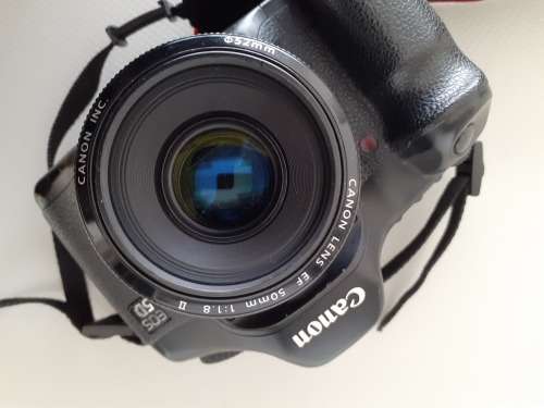 Used Canon 5D camera with Canon 50 mm f1.8 lens plus battery , charger and  plus Yongnuo speedlite a