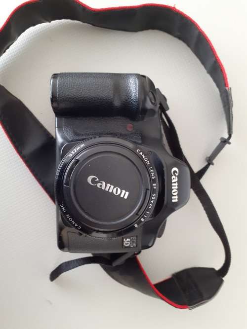Used Canon 5D camera with Canon 50 mm f1.8 lens plus battery , charger and  plus Yongnuo speedlite a