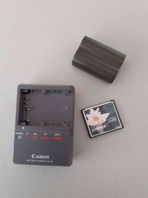 Used Canon 5D camera with Canon 50 mm f1.8 lens plus battery , charger and  plus Yongnuo speedlite a