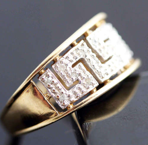 9CT YELLOW AND WHITE GOLD DIAMOND BROAD SHANK RING. INTERESTING GREEK MOTIF DESIGN. 19 DIAMONDS!