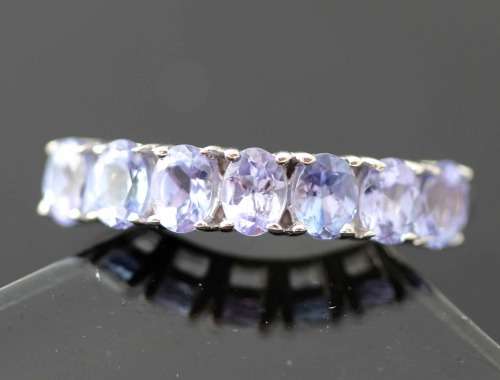 TANZANITE HALF ETERNITY RING IN '925' STERLING SILVER RING. DEEP LILAC COLOUR.