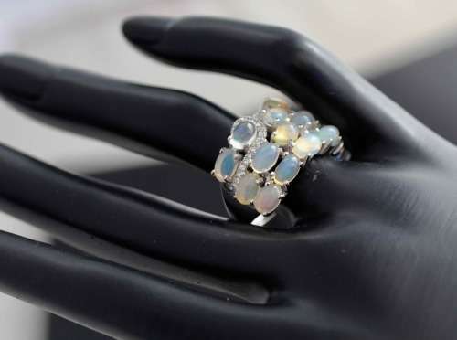 BROAD BAND STERLING SILVER RING SET WITH AAA QUALITY RAINBOW WHITE OPALS.