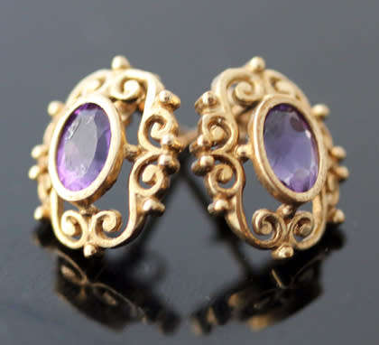 VINTAGE 9CT YELLOW GOLD FILIGREE STUD EARRINGS WITH OVAL FACETED AMETHYSTS. 375