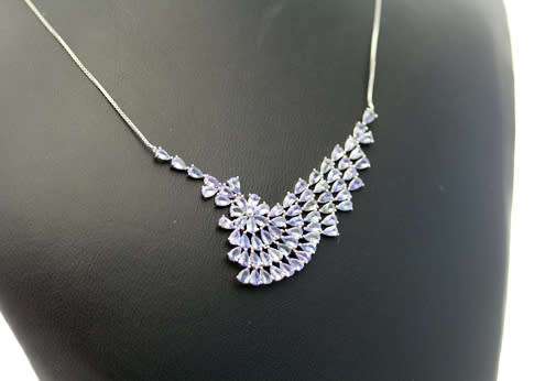 DRAMATIC AND ELEGANT TANZANITE AND STERLING SILVER WAVE-LIKE RIGID FEATURE PENDANT. BOX CHAIN