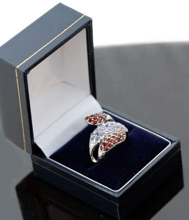 DRAMATIC TRIPLE CROSSOVER STERLING SILVER RING WITH BLUE TANZANITE AND MOZAMBICAN GARNETS. 925