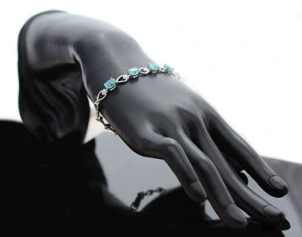 ELEGANT STERLING SILVER BRACELET WITH NEON BLUE APATITE CABOCHON GEMSTONES. DAINTY, OPENWORK DESIGN.