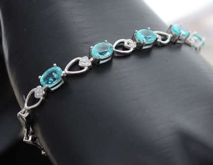 ELEGANT STERLING SILVER BRACELET WITH NEON BLUE APATITE CABOCHON GEMSTONES. DAINTY, OPENWORK DESIGN.