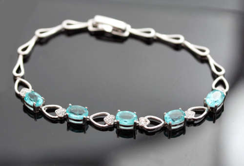 ELEGANT STERLING SILVER BRACELET WITH NEON BLUE APATITE CABOCHON GEMSTONES. DAINTY, OPENWORK DESIGN.