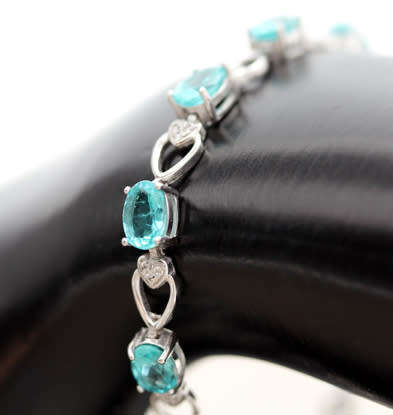 ELEGANT STERLING SILVER BRACELET WITH NEON BLUE APATITE CABOCHON GEMSTONES. DAINTY, OPENWORK DESIGN.