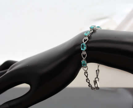 ELEGANT STERLING SILVER BRACELET WITH NEON BLUE APATITE CABOCHON GEMSTONES. DAINTY, OPENWORK DESIGN.