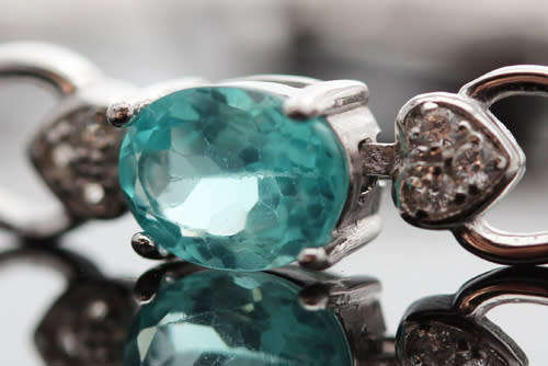 ELEGANT STERLING SILVER BRACELET WITH NEON BLUE APATITE CABOCHON GEMSTONES. DAINTY, OPENWORK DESIGN.