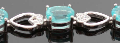 ELEGANT STERLING SILVER BRACELET WITH NEON BLUE APATITE CABOCHON GEMSTONES. DAINTY, OPENWORK DESIGN.