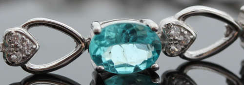 ELEGANT STERLING SILVER BRACELET WITH NEON BLUE APATITE CABOCHON GEMSTONES. DAINTY, OPENWORK DESIGN.