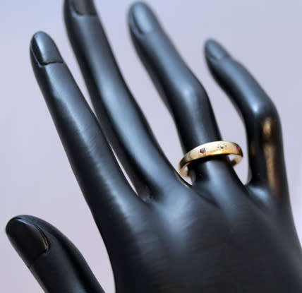 ANTIQUE ENGLISH 9CT GOLD BAND GYPSY SET RUBY AND STAR SET DIAMOND RING. circa early 1900's