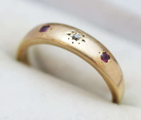ANTIQUE ENGLISH 9CT GOLD BAND GYPSY SET RUBY AND STAR SET DIAMOND RING. circa early 1900's