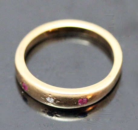 ANTIQUE ENGLISH 9CT GOLD BAND GYPSY SET RUBY AND STAR SET DIAMOND RING. circa early 1900's