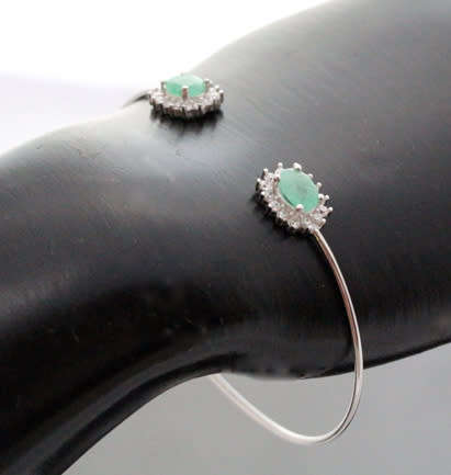CONTEMPORARY EMERALD AND BRIGHT WHITE STONE STERLING SILVER BANGLE. 925