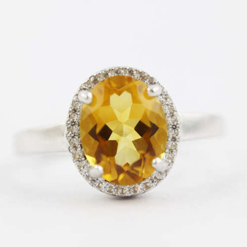 CONTEMPORARY DESIGN STERLING SILVER RING - OVAL CITRINE SOLITAIRE WITH CUBIC ZIRCONIA HALO. 925