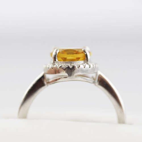 CONTEMPORARY DESIGN STERLING SILVER RING - OVAL CITRINE SOLITAIRE WITH CUBIC ZIRCONIA HALO. 925