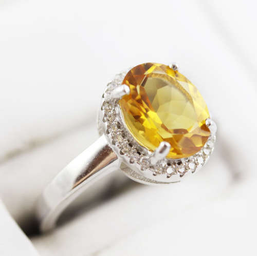 CONTEMPORARY DESIGN STERLING SILVER RING - OVAL CITRINE SOLITAIRE WITH CUBIC ZIRCONIA HALO. 925