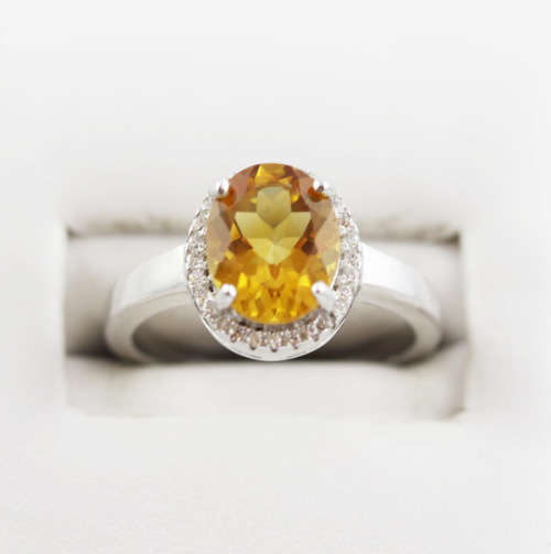 CONTEMPORARY DESIGN STERLING SILVER RING - OVAL CITRINE SOLITAIRE WITH CUBIC ZIRCONIA HALO. 925