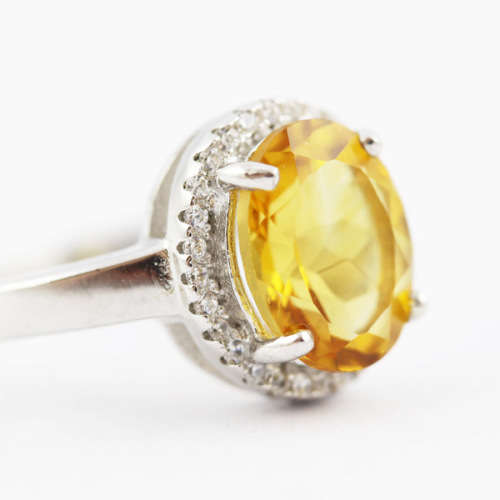 CONTEMPORARY DESIGN STERLING SILVER RING - OVAL CITRINE SOLITAIRE WITH CUBIC ZIRCONIA HALO. 925