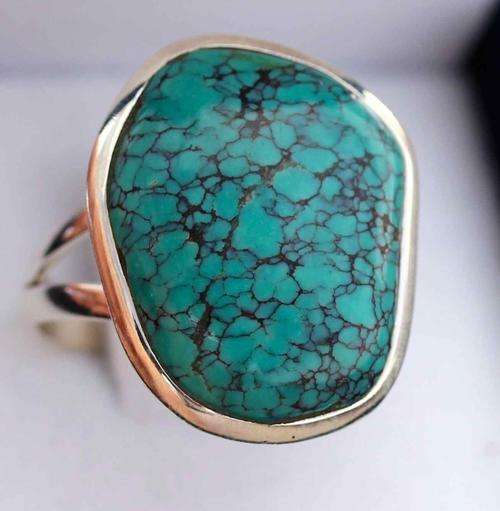 NATURAL TURQUOISE GEMSTONE WITH INTERESTING DARK INCLUSIONS. LARGE RING SET IN STERLING SILVER!